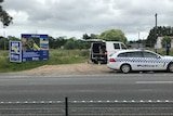 A for sale sign and police cars outside the Tyabb property's gate.