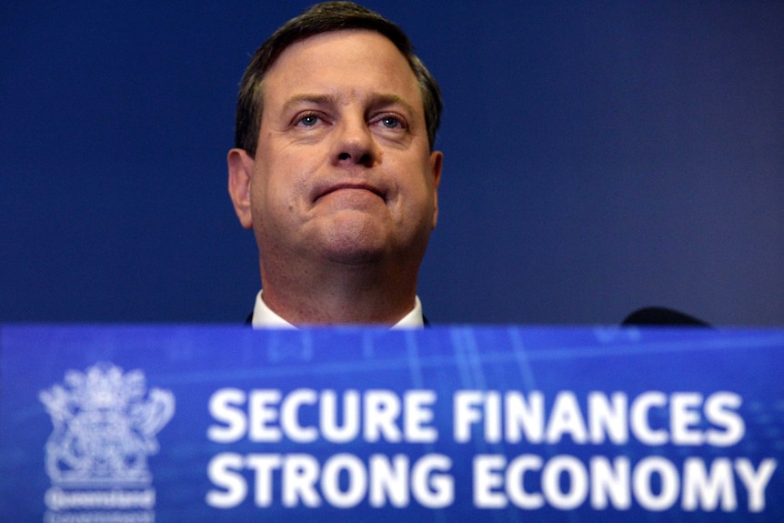 LNP leader Tim Nicholls behind a lectern on stage at a conference.