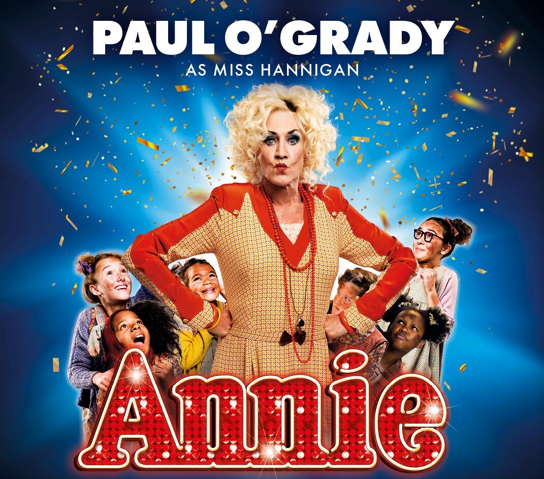 A poster for Annie The Musical, starring Paul O'Grady in character as Miss Hannigan