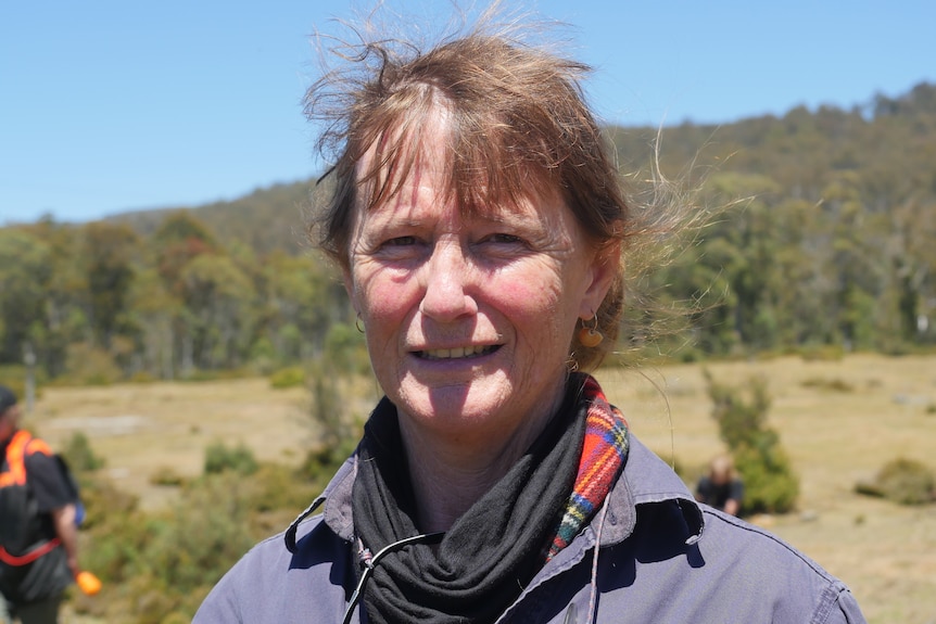 A woman on a sunny day in the Tasmanian bush.