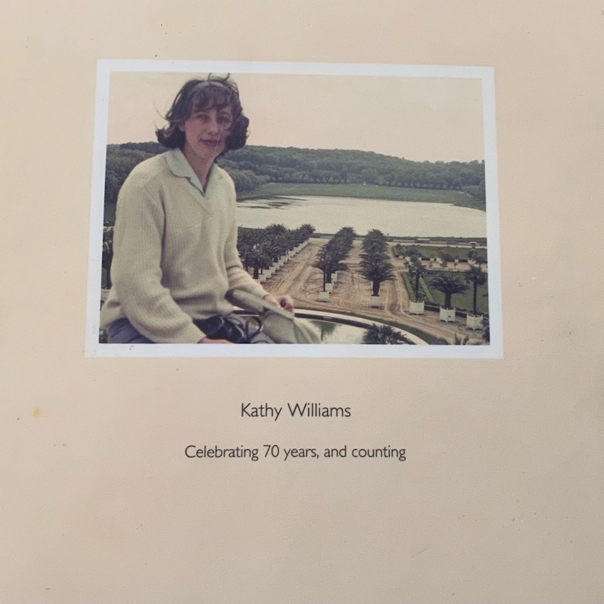 The cover of a photo album with a photo of Kathy as a young woman
