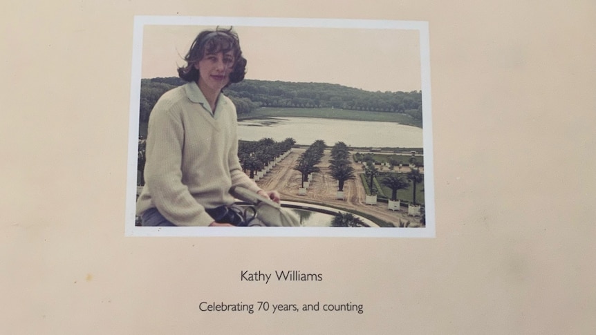 The cover of a photo album with a photo of Kathy as a young woman
