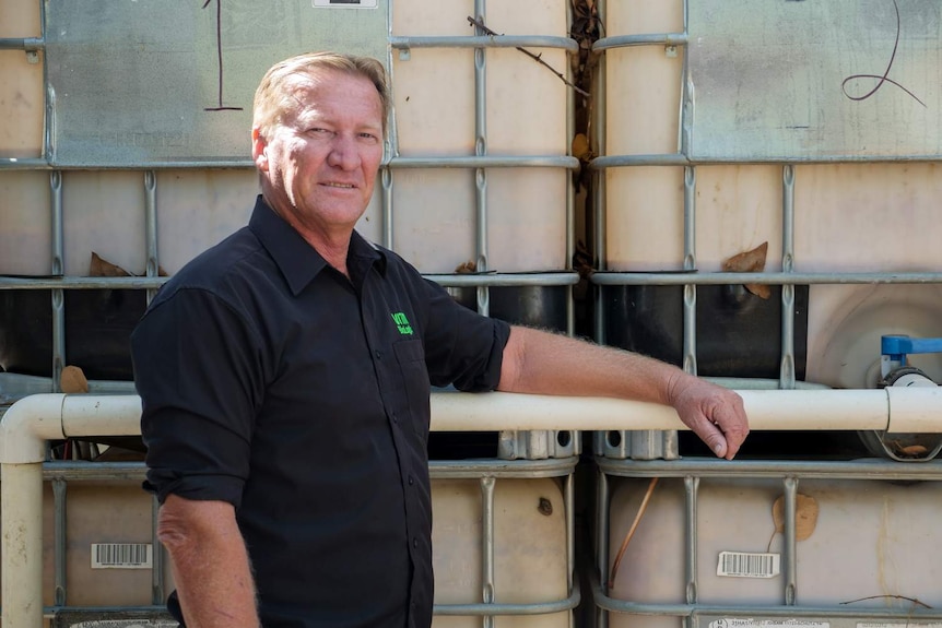 VRM's Gil Napper standing in front of the bio-fertiliser fermentation tanks.