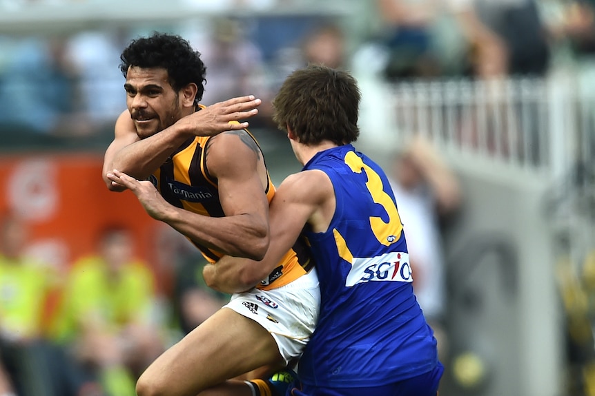 West Coast Eagles player Andrew Gaff tackles Hawthorn player Cyril Rioli during the 2015 AFL grand final.