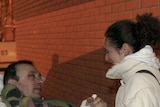 A victim of a bomb explosion at Domodedovo Airport talks to a relative