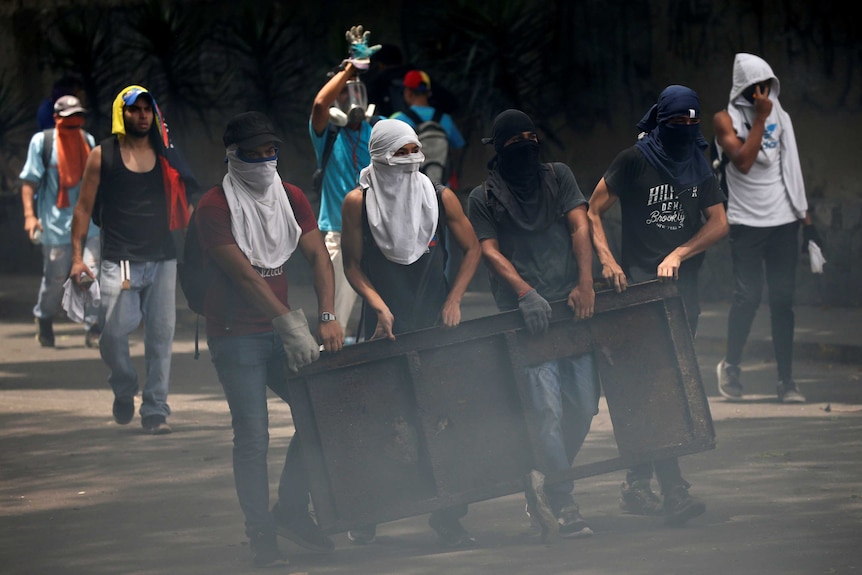 Demonstrators build a barricade during the 'mother of all marches' against President Nicolas Maduro in Caracas Venezuela 19/4/17