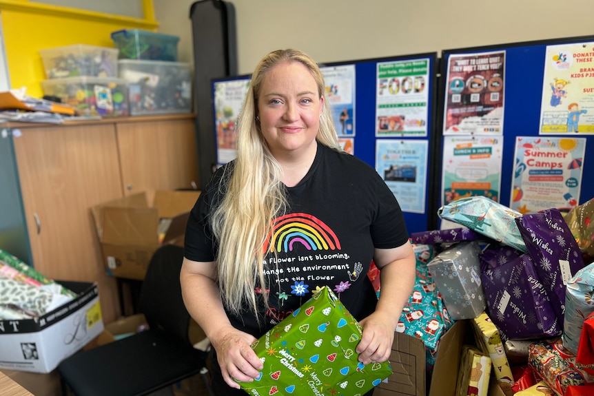 A woman holds a present.