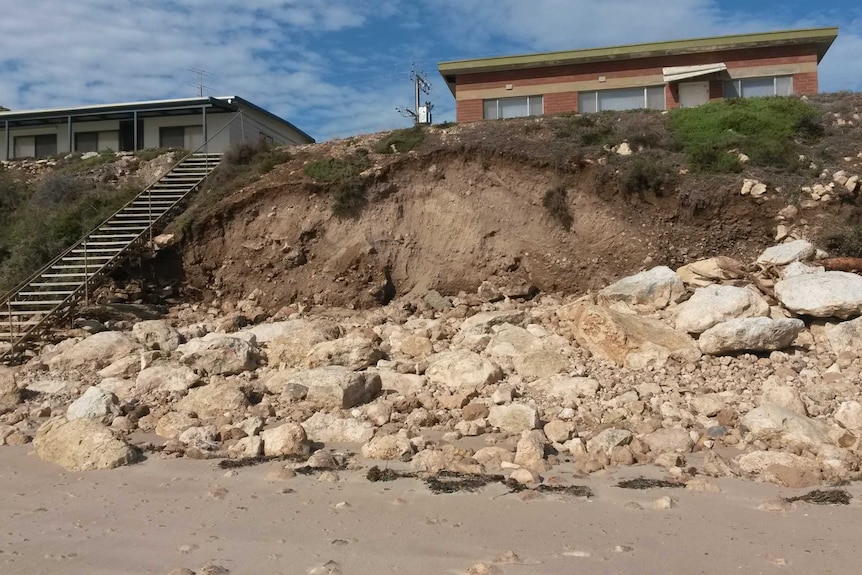 Two beach shacks just a few meters away from a cliff caused by storm erosion at Point Turton in South Australia.