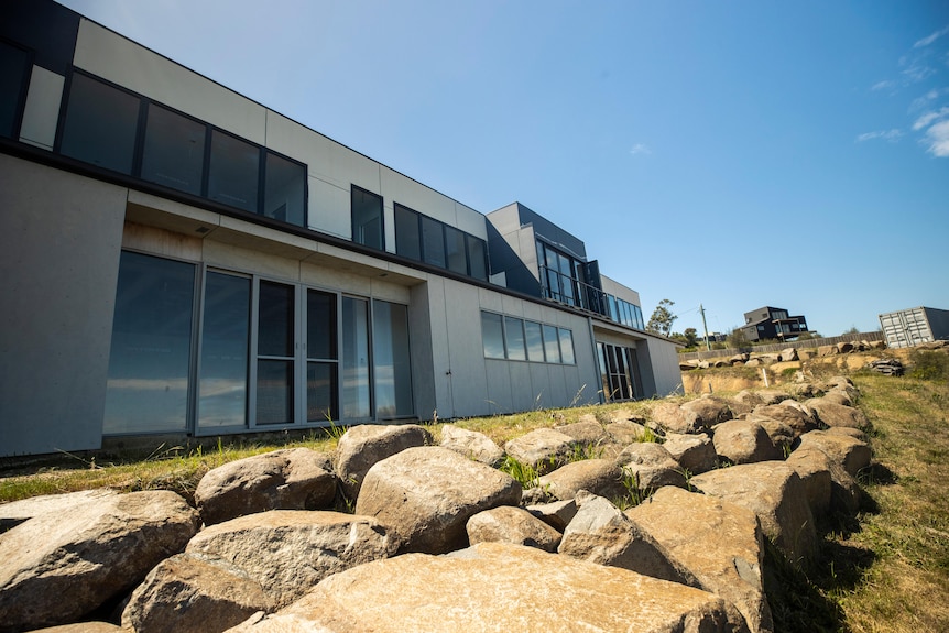 A unfinished two-storey home with grey, flat walls in a modern style.