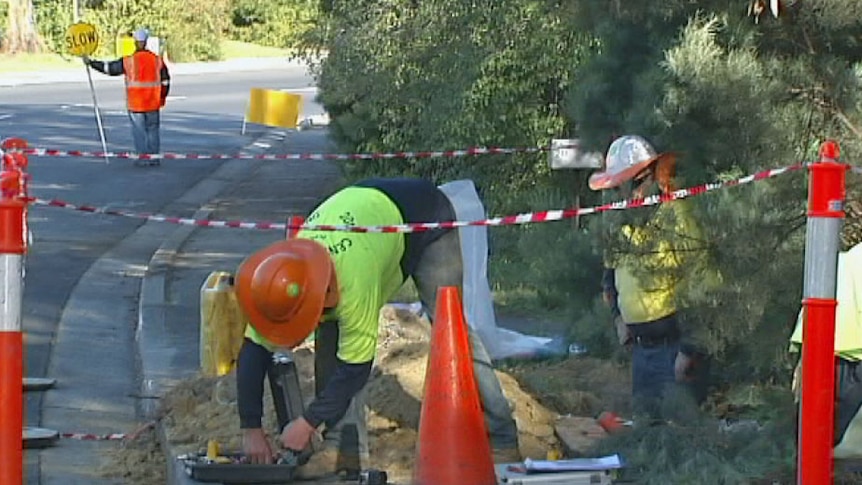 Workers install NBN cables at Kingston near Hobart.