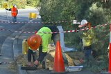 Workers install NBN cables at Kingston near Hobart.