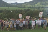 Gloucester residents standing in the Valley holding placards protesting the proposed Rocky Hill coal mine project