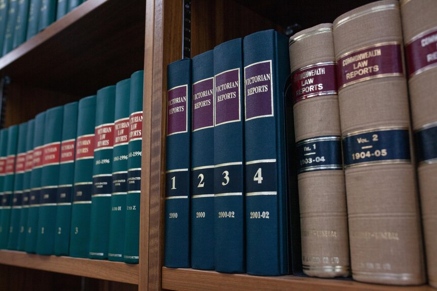 A row of Victorian and Commonwealth law reports in a bookshelf.