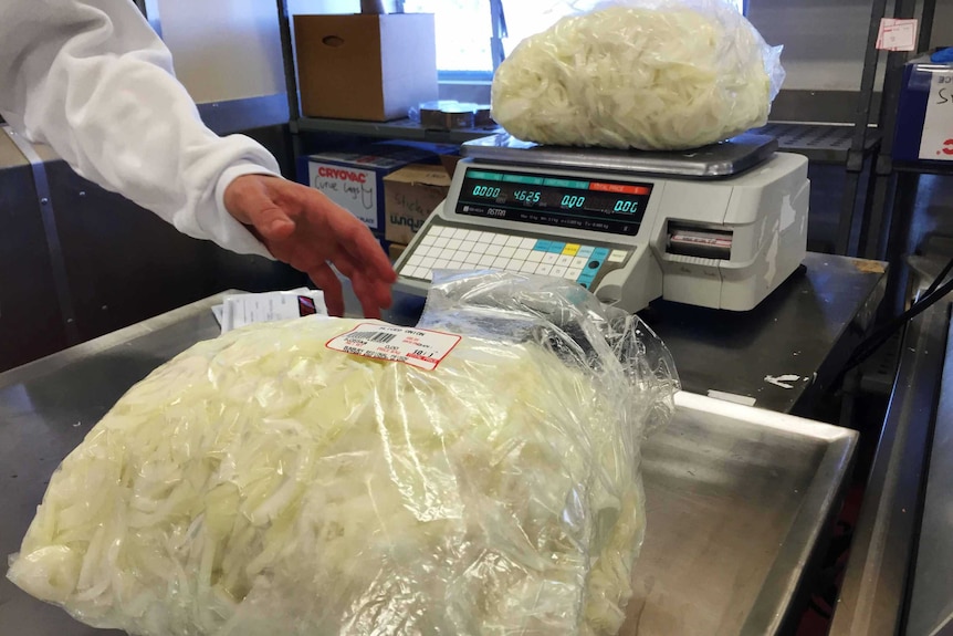 Weighing a bag of onions on a digital scale