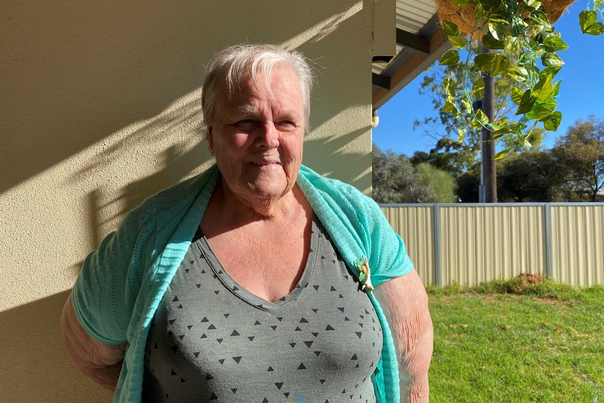 75-year-old Marjorie Patullo stands on her verandah