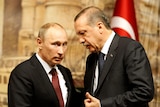  Tayyip Erdogan leans down to talk to Vladimir Putin 