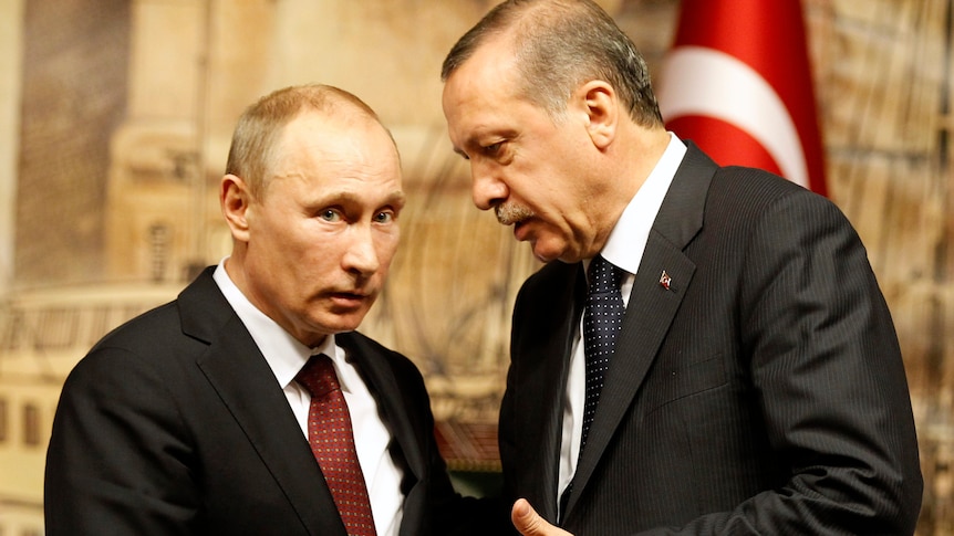  Tayyip Erdogan leans down to talk to Vladimir Putin 