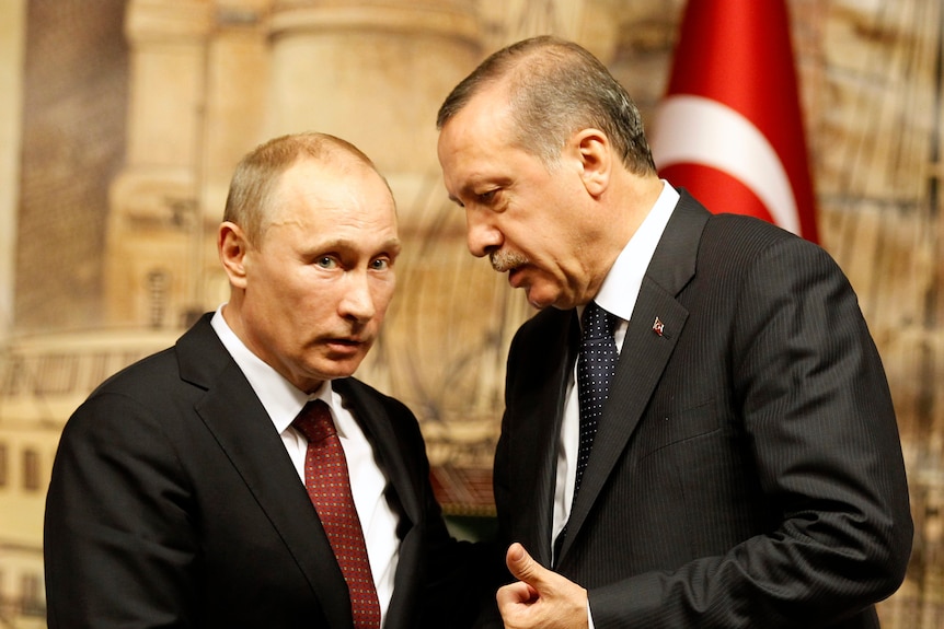 Recep Tayyip Erdogan leans down to talk to Vladimir Putin 