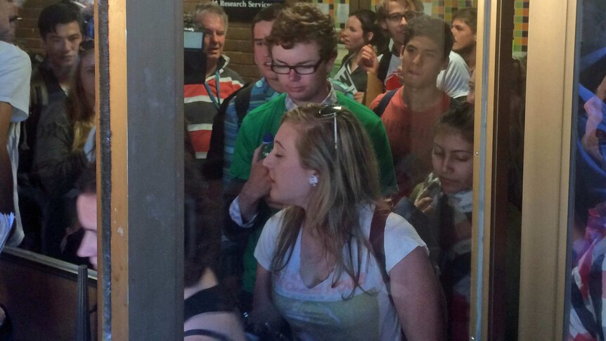 Student protesters attempted to force their way past security into the admin building at ANU on May 21, 2014.