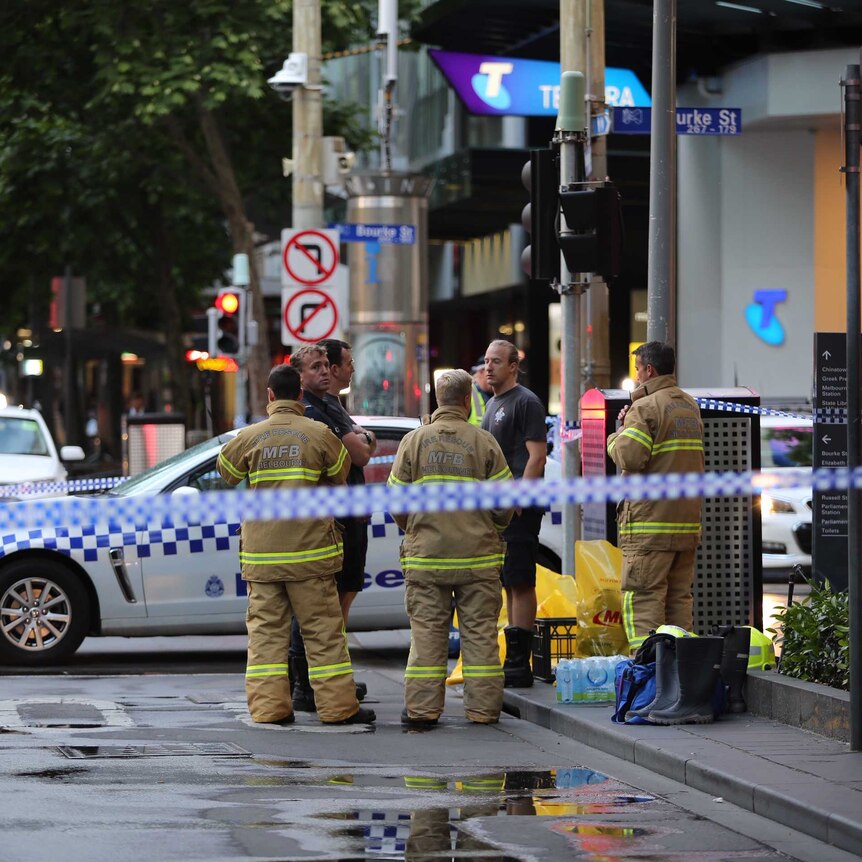 Emergency services staff at Bourke Street following a fatal stabbing.
