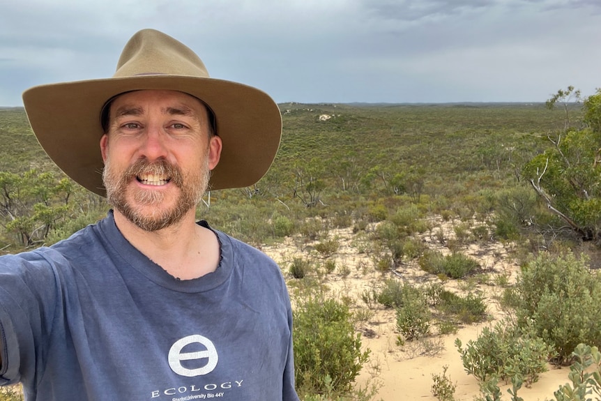 A man with a hat in a national park.