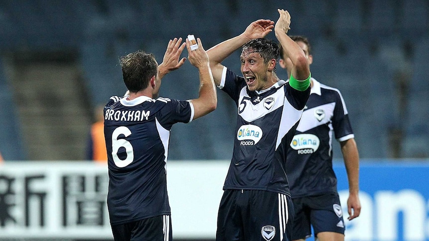 Leigh Broxam and Mark Milligan celebrate a goal