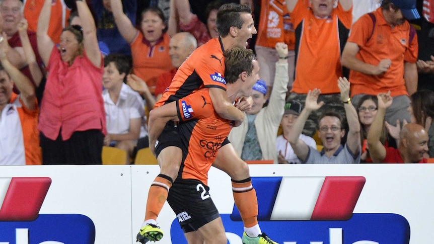 Matthew Smith and Liam Miller celebrate a goal for Brisbane