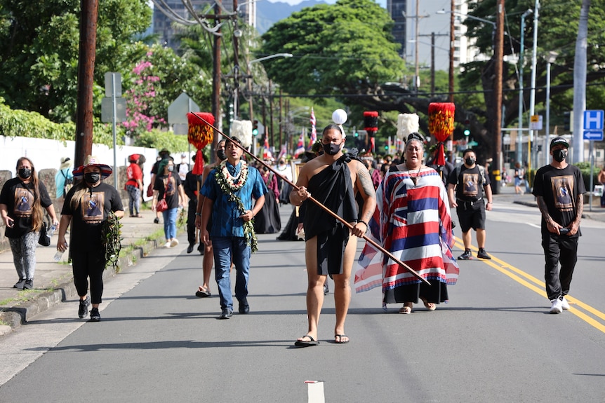 Hawaiians march down a street.