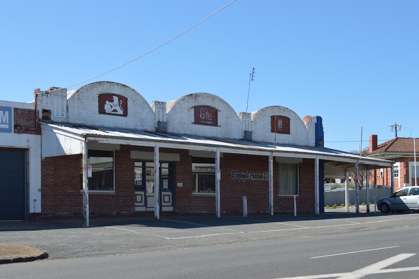 Abandoned mechanical garage with faded Holden signs