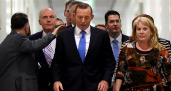 Ousted Prime Minister Tony Abbott receives a pat on the shoulder after losing the Liberal Party leadership.