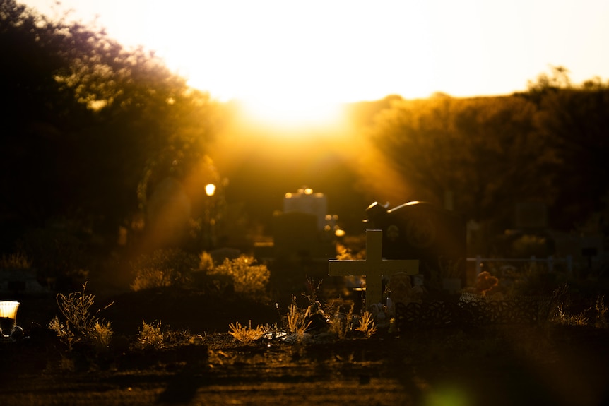 Graves pictured at sunrise in a cemetery