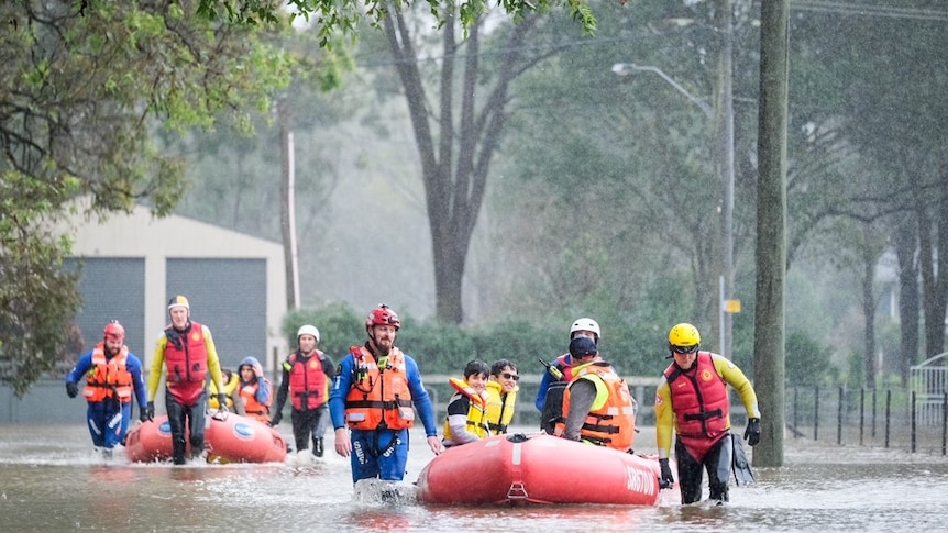 Emergency services help the SES perform a flood rescue in Sydney