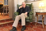 Don Neil sits in an armchair in Hadley's Orient Hotel