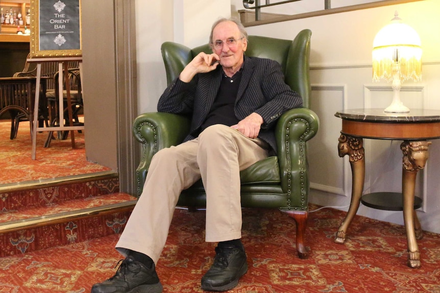 Don Neil sits in an armchair in Hadley's Orient Hotel