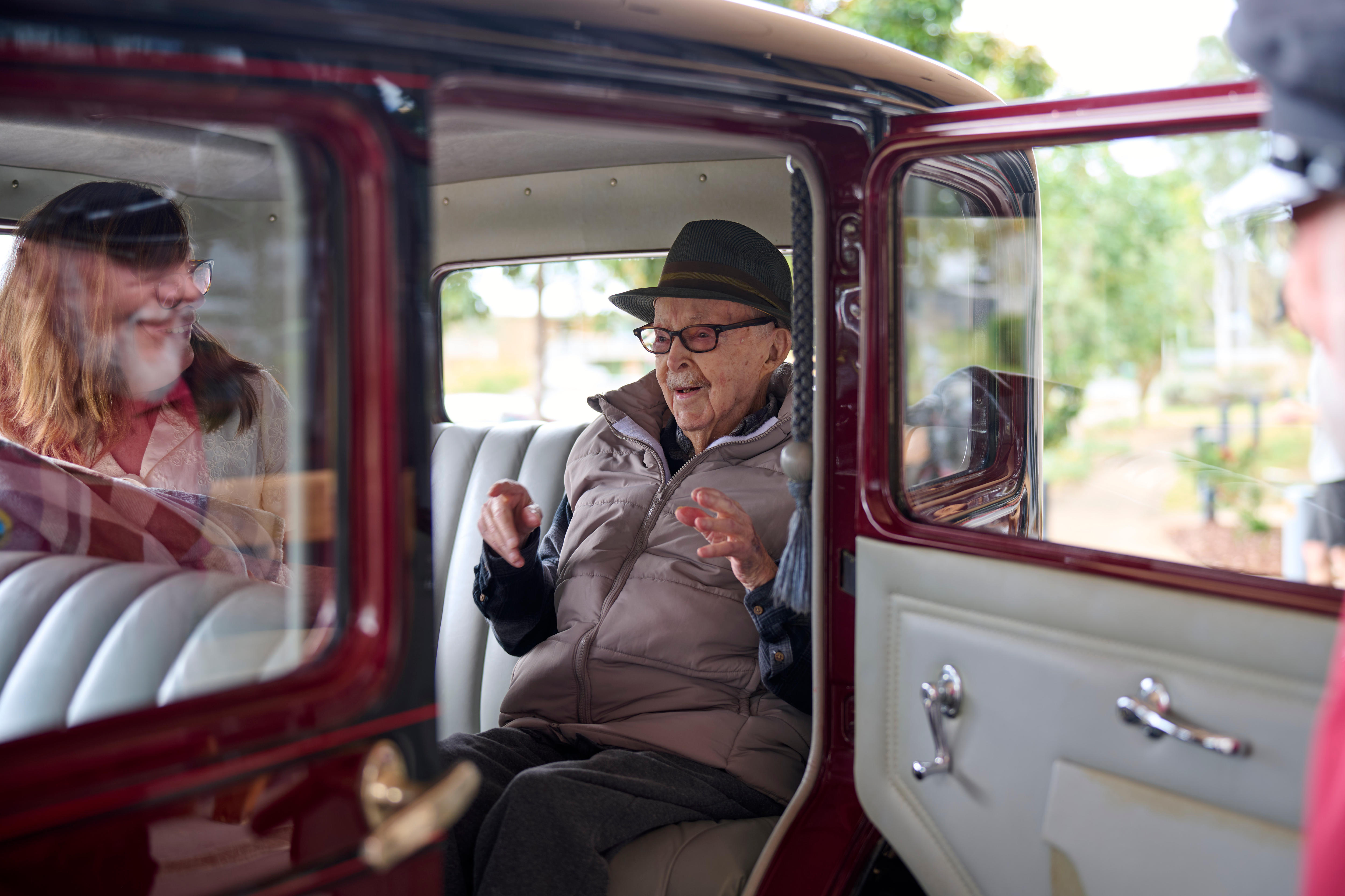 Australia's oldest man sits in a vintage car and smiles
