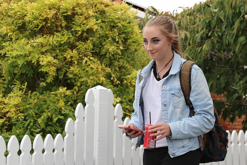 Haley Oakley walks along a street