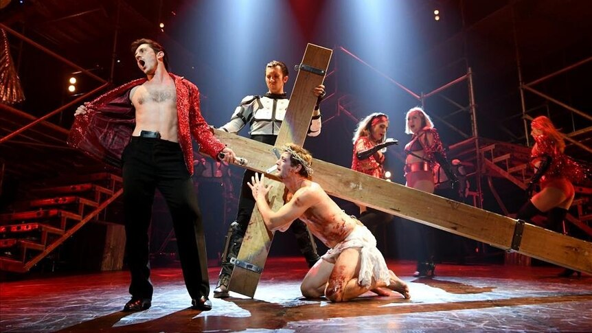 Rob Mills plays Jesus Christ Superstar, he's on stage kneeling on the floor carrying a cross on his back