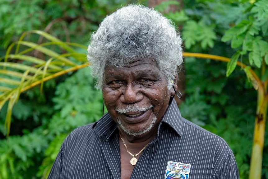 Yolngu elder Terry Yumbulul smiling at the camera.