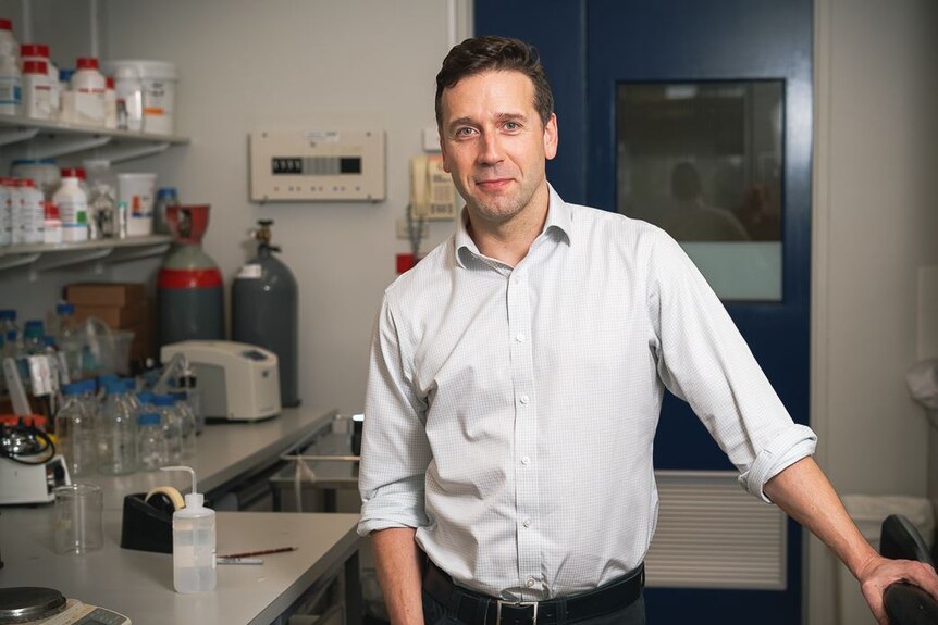 Molecular microbiologist Professor Geraint Rogers stands inside a laboratory.
