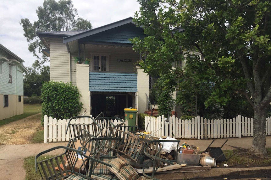Chairs are piled up outside a home in Lismore