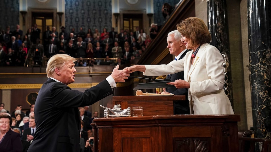 President Donald Trump shakes hands with House Speaker Nancy Pelosi.