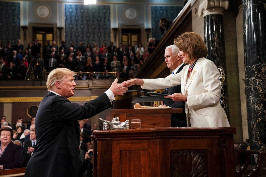 President Donald Trump shakes hands with House Speaker Nancy Pelosi.