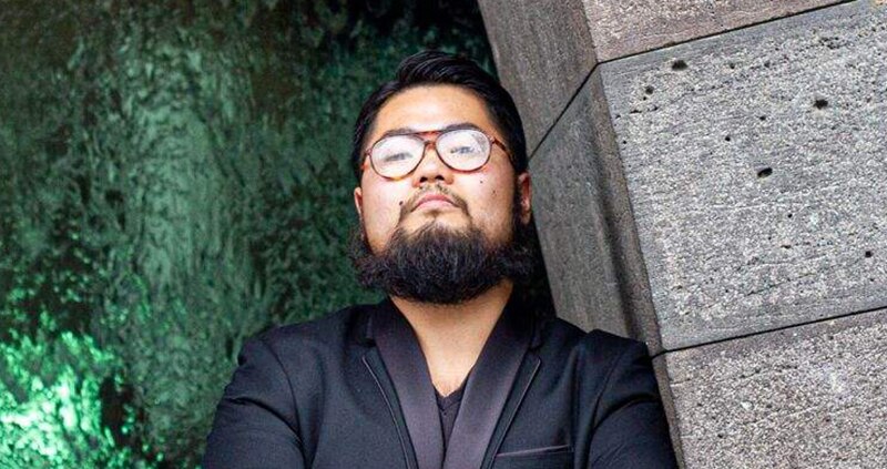 Artist Badiucao stands in front of the National Gallery of Victoria