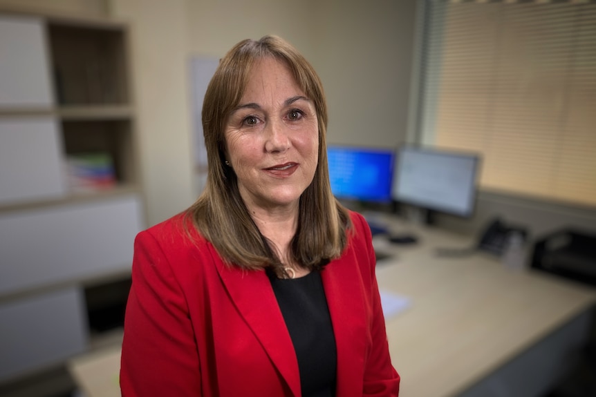 Woman stands in office