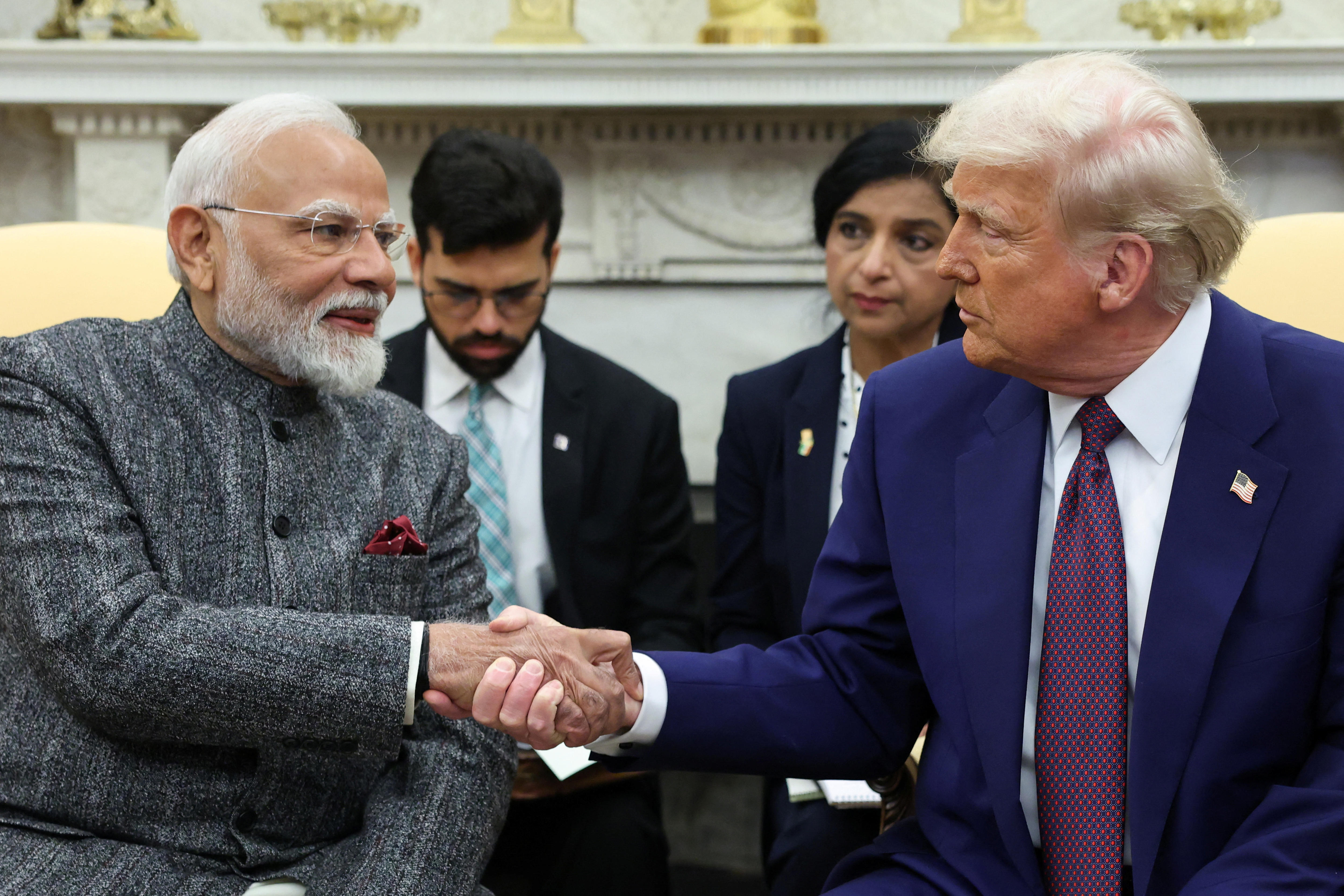 The Prime Minister of Indian hakes hands with US President Donald Trump.