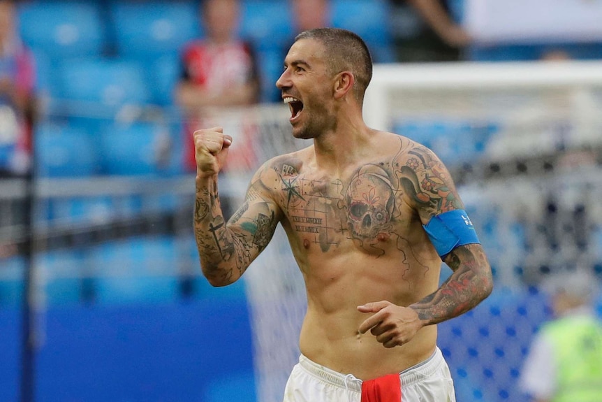 A shirtless Aleksander Kolarov fistpumps after a win over Costa Rica