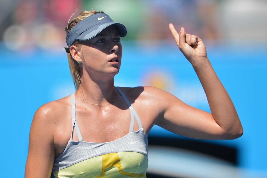 Sharapova gestures to the umpire
