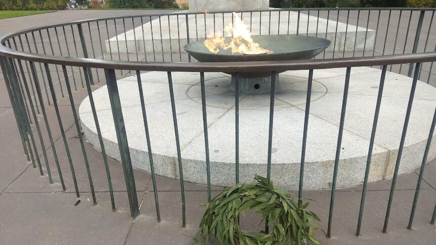 A wreath of gumleaves in front of the Eternal Flame.