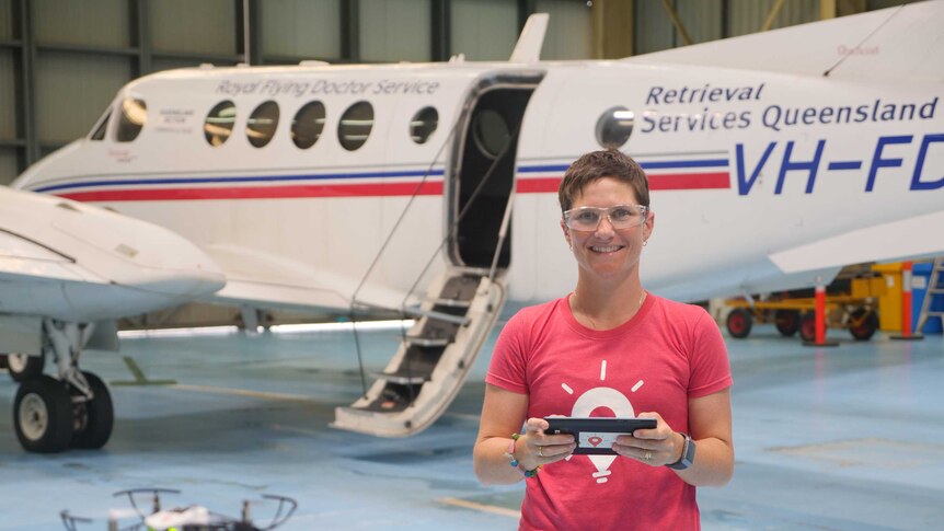 Woman flies drone in front of plane.