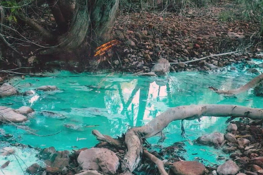 Bright blue-coloured water in river after rain near Mount Oxide copper mine, north of Mount Isa.